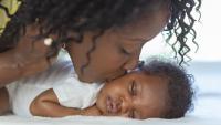 mother kissing baby